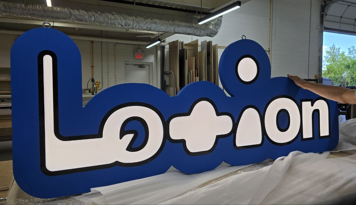 The completed sign at the Brience shop, checked and wrapped before handover.