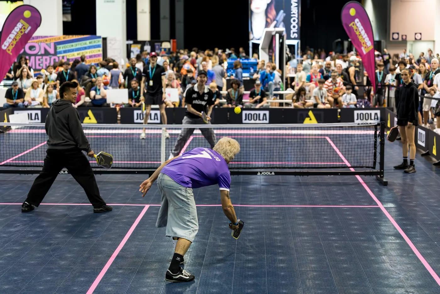 The creator pickleball arena: a booth that is simultaneously its own broadcast, VidCon 2026 expo floor, Anaheim