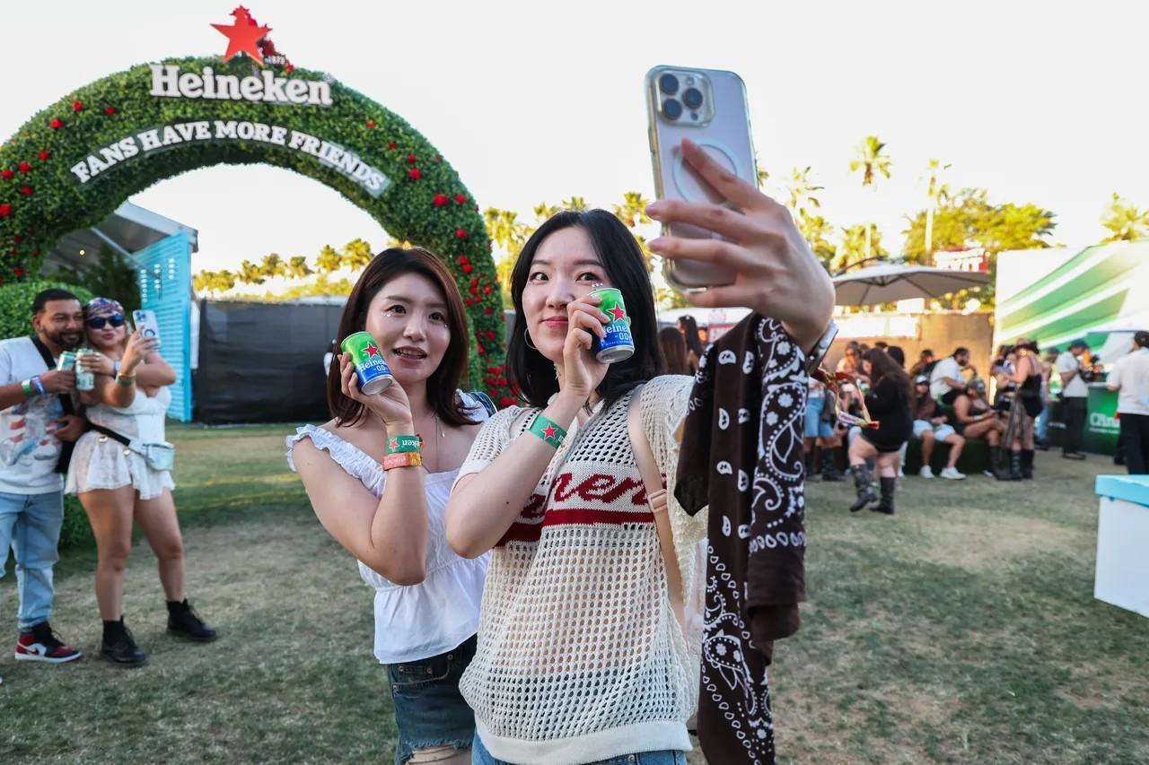 Smart wearable wristband on a beverage can, soft amber lighting, low-key festival environment, Coachella 2026