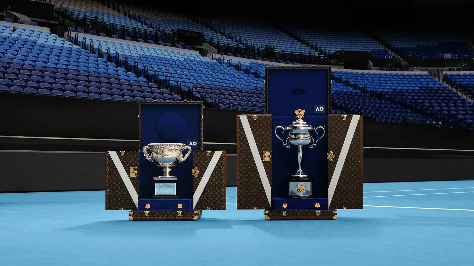Two Louis Vuitton Trophy Trunks displayed courtside at the 2026 Australian Open, each housing a championship cup